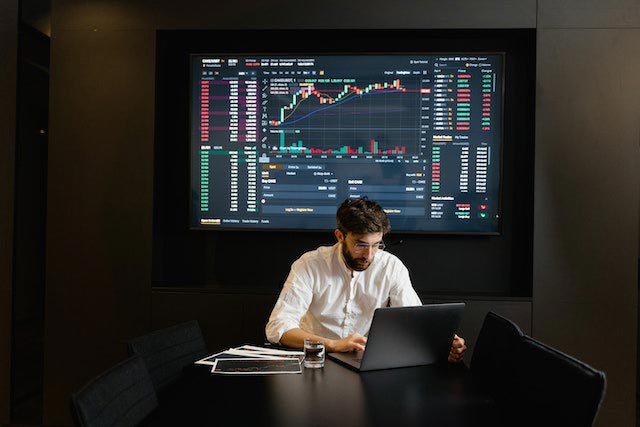 man-in-white-dress-shirt-using-laptop